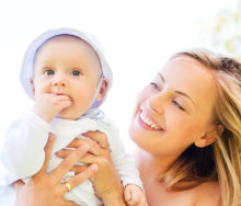 adult woman holding an infant