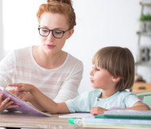 adult woman teaching a toddler