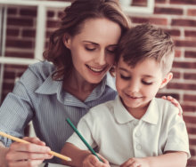 adult woman teaching a kid